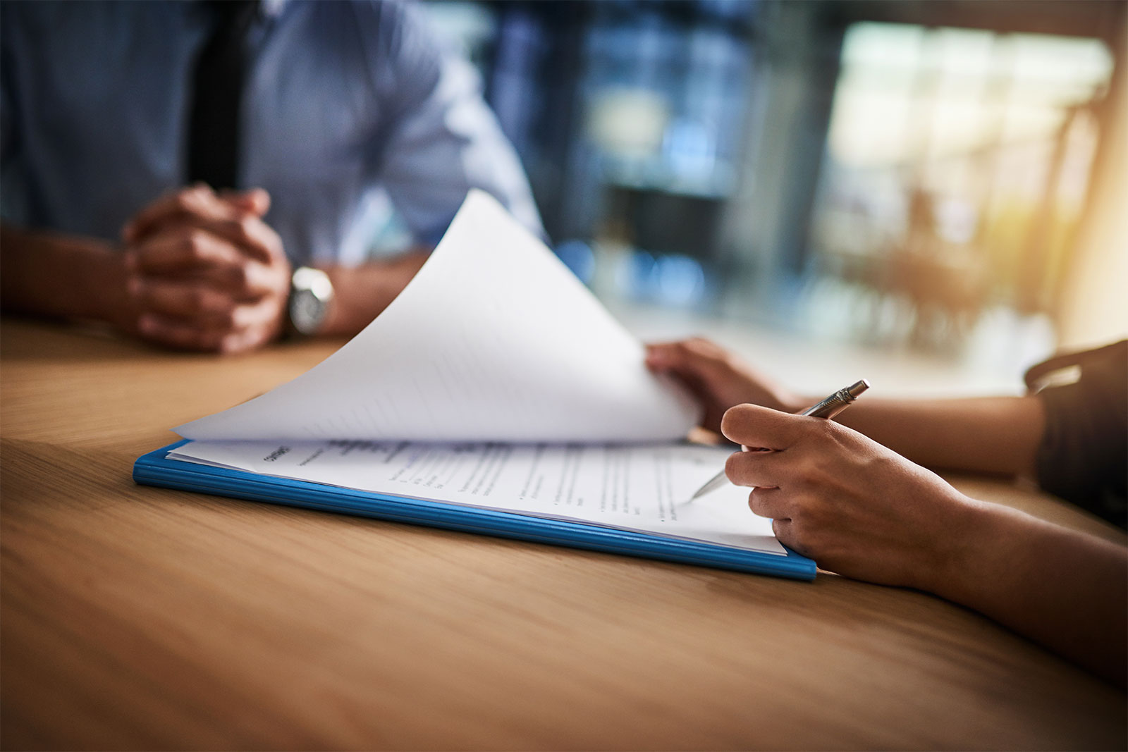 Image of person signing documents